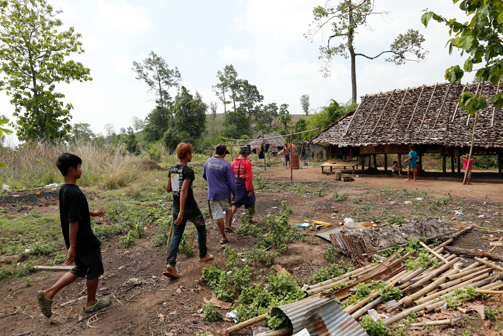 Men walk into a village of displaced Karen exiles called Kyout Sat outside of Mae Sot, Thailand, April 27, 2015. (Derek Gee / Buffalo News)
