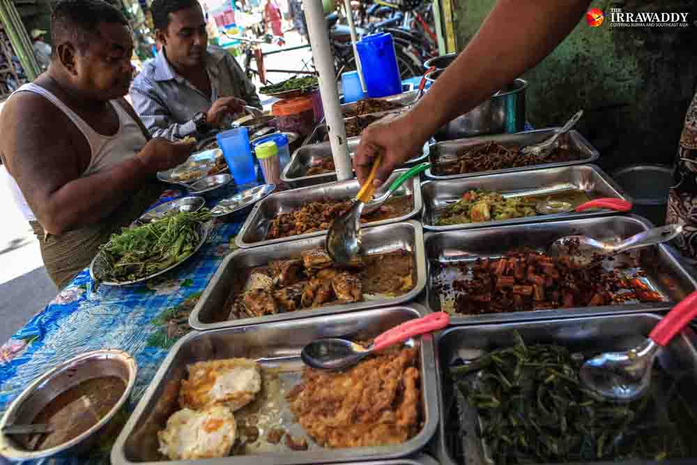 Two men eat street food for lunch in downtown Rangoon. (Photo: J Paing / The Irrawaddy)