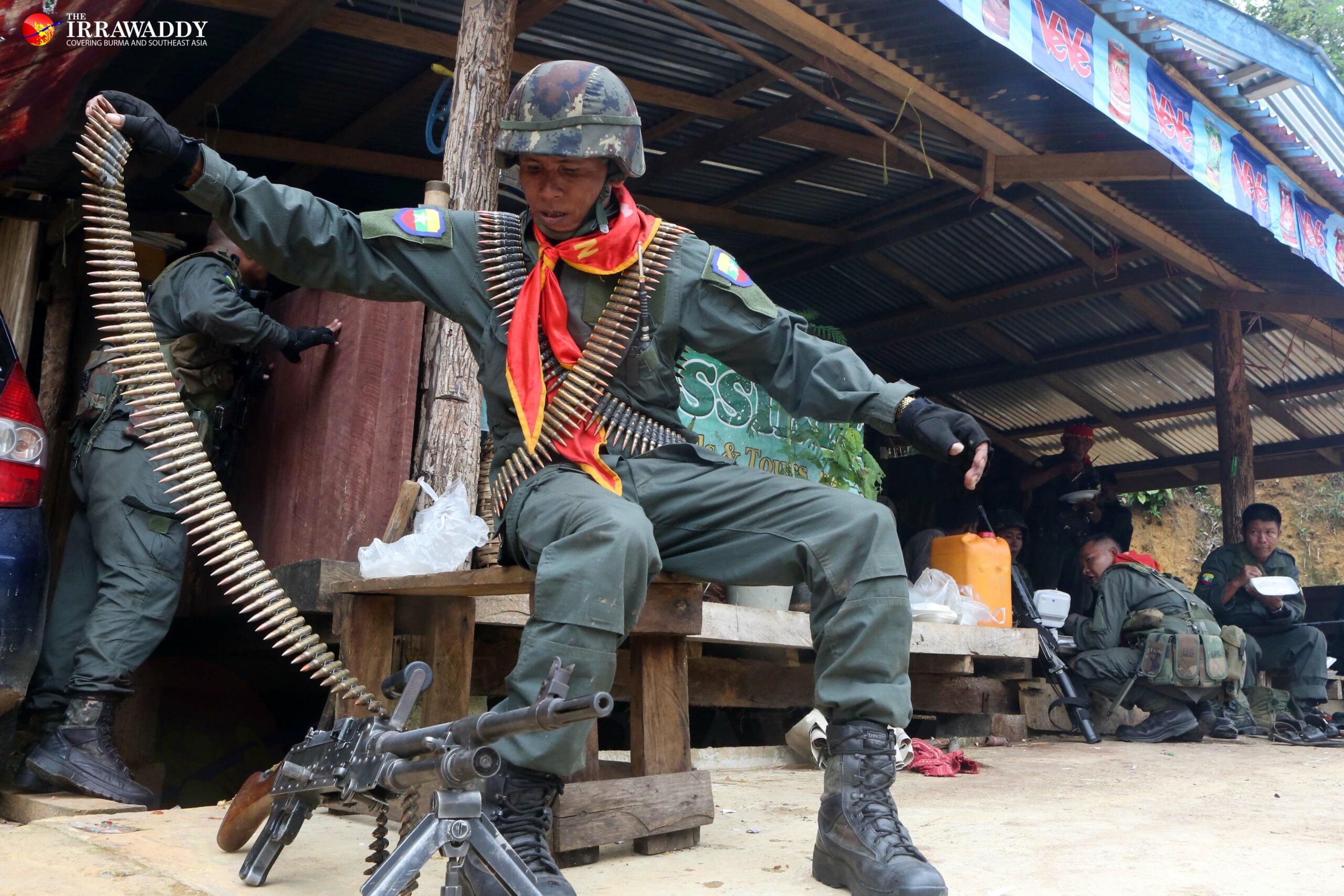 A Border Guard Force soldier loads a machine gun on the front line of clashes theMae Tha Waw area of Hlaingbwe Township, Karen State 