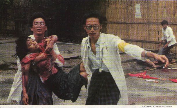 The iconic photo in which medical student Win Zaw (L) and house surgeon Dr. Saw Lwin carry 16-year-old pro-democracy protestor Win Maw Oo to an ambulance after she was fatally shot on September 18, 1988. (Photo: S. Lehman / Visions)