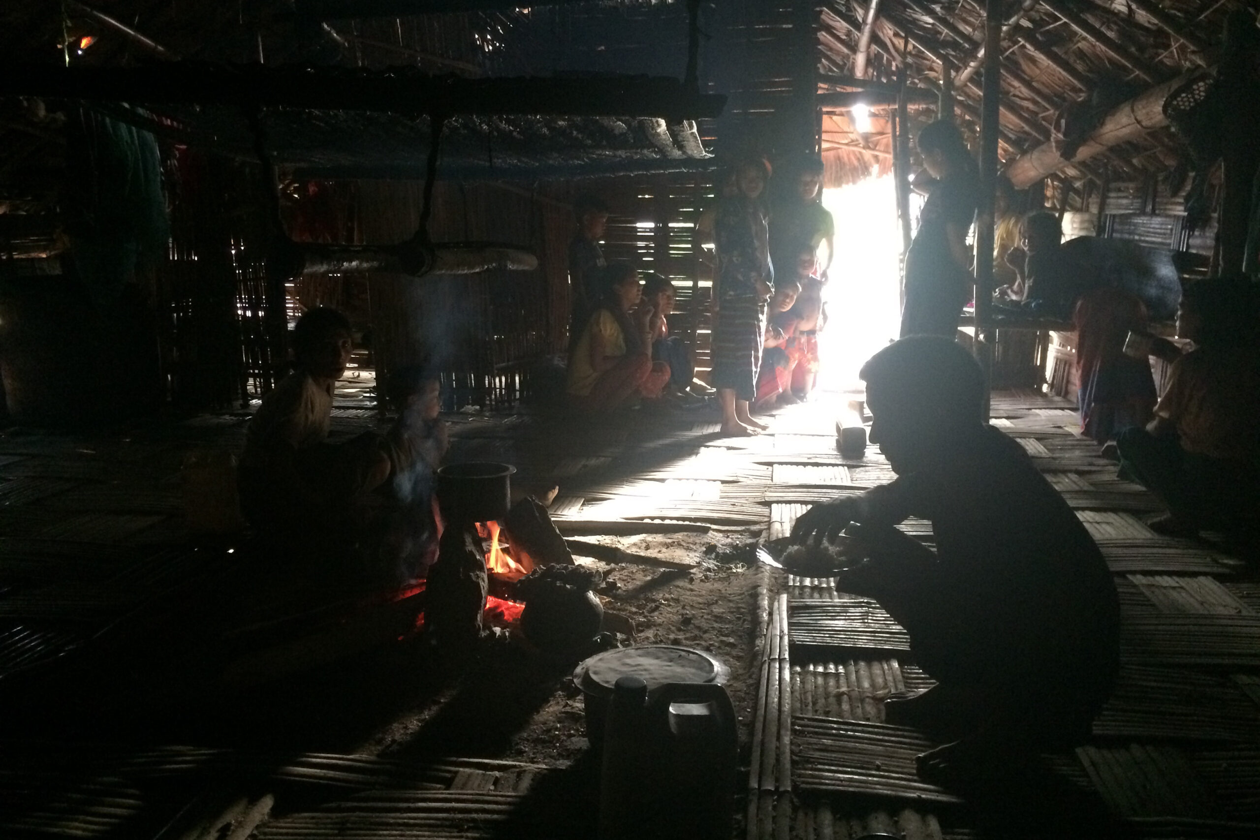 U Par Loon and his family have dinner inside his home. (Photo: Nan Tin Htwe)